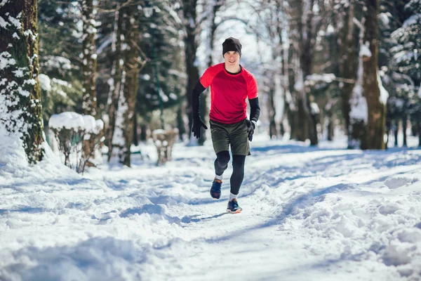 Молодой Человек Бежит Зимой Парке — стоковое фото