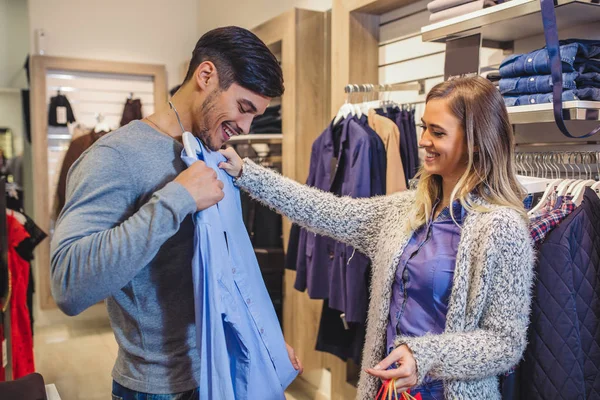 Young Man Consults Girlfriend While Selecting Shirt — Stock Photo, Image