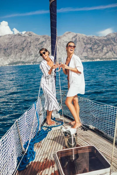 Girls enjoy the vacation on a yacht. Party on a sailboat.