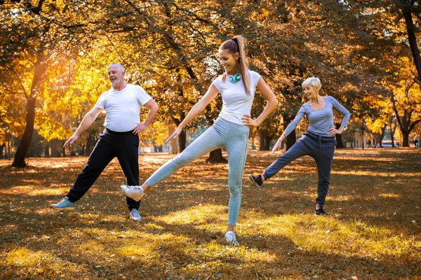 Senior Man Woman Young Female Instructor Workout Fresh Air Outdoor — Stock Photo, Image