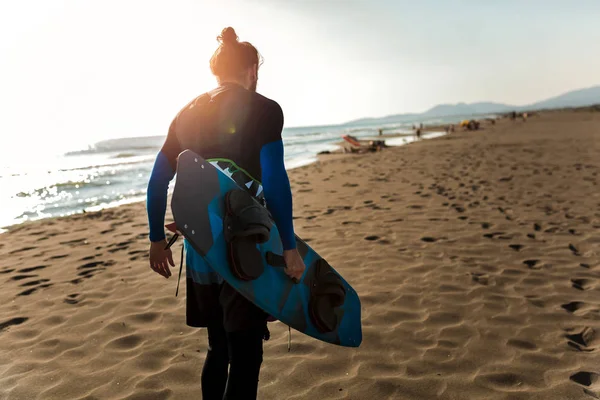 Portrait of surfer man with surf board on the beach. Summer sport activity