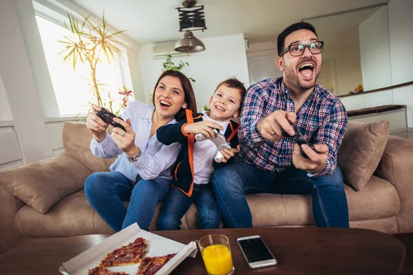 Familia Feliz Sentada Sofá Jugando Videojuegos Comiendo Pizza —  Fotos de Stock