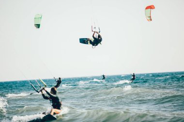 Profesyonel kiter zor hüner güzel bir arka plan üzerinde yapar. Kitesurfing Kiteboarding eylem fotoğraflar adam dalgalar arasında hızlı bir şekilde gider