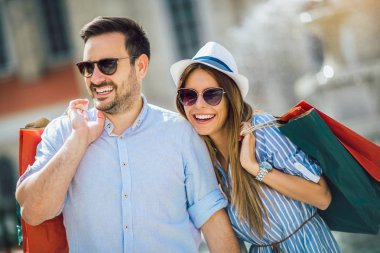 Güzel genç bir çift alışveriş yapıyor, şehirde eğleniyor.