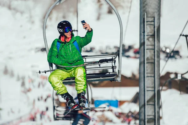 Happy Skier Taking Selfie Photo Smart Cell Phone Camera Sitting — Stock Photo, Image