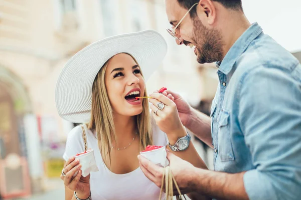 Leende par i shopping med glass och påsar — Stockfoto