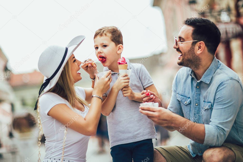 Young happy family spending their weekend with son. They are eat