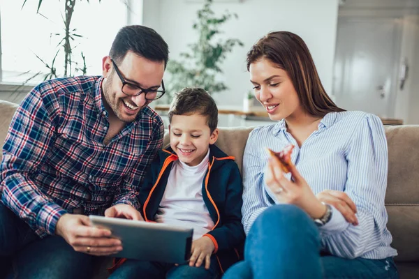 Happy family spending time at home and looking something fanny o — Stock Photo, Image