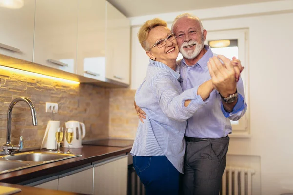 Pareja mayor bailando juntos en la cocina —  Fotos de Stock