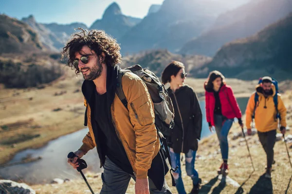 Grupo de excursionistas caminando en una montaña en el día de otoño — Foto de Stock