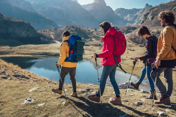 Group of hikers walking on a mountain at autumn day — Stock Photo, Image