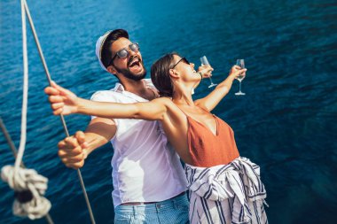 Loving couple spending happy time on a yacht at sea. Luxury vaca clipart