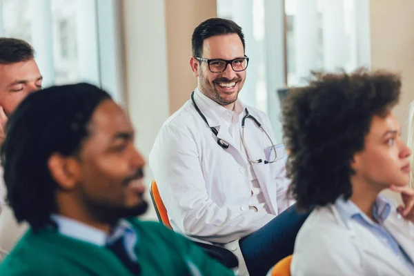 Group of happy doctors on seminar in lecture hall at hospital — Stock Photo, Image