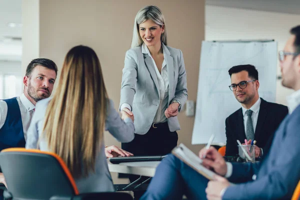 Ofiste bir müşteri ile el sallayarak iş 