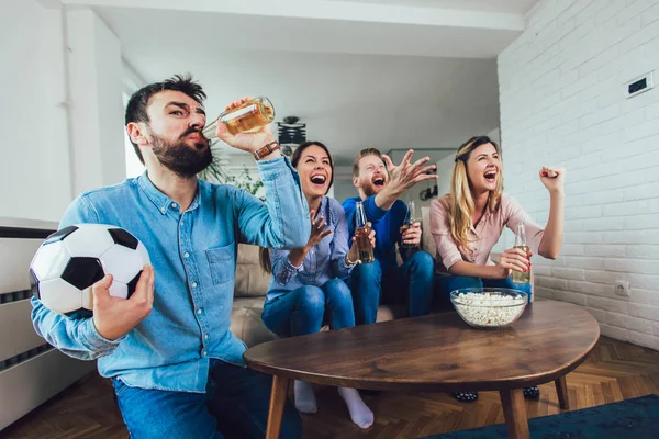 Happy friends or football fans watching soccer on tv and celebra — Stock Photo, Image