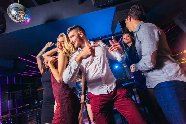 Grupo de amigos de fiesta en un club nocturno — Foto de Stock