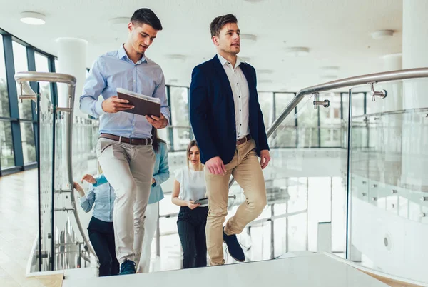 Group of businessmen and businesswomen walking and taking stairs — Stock Photo, Image