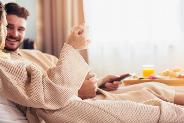 Young happy couple having breakfast in luxury hotel room. — Stock Photo, Image