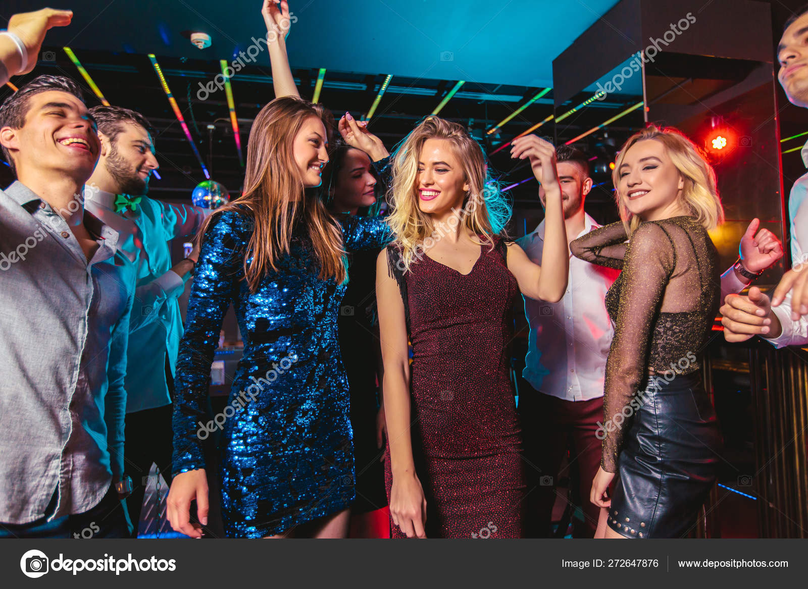 Young happy people are dancing in club. Nightlife and disco conc ...