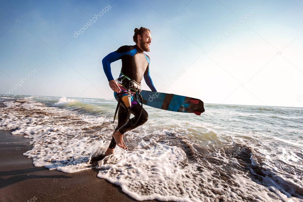 Portrait of surfer man with surf board on the beach. Summer spor