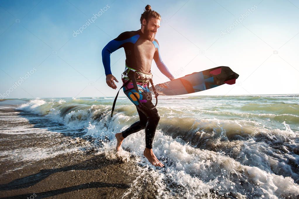 Portrait of surfer man with surf board on the beach. Summer spor