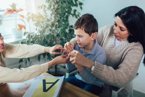 Smiling deaf boy learning sign language. Selective focus. — Stock Photo, Image