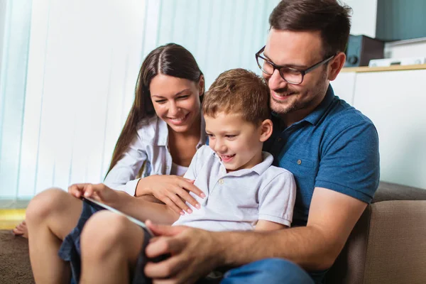 Happy family spending time at home and looking something fanny o — Stock Photo, Image