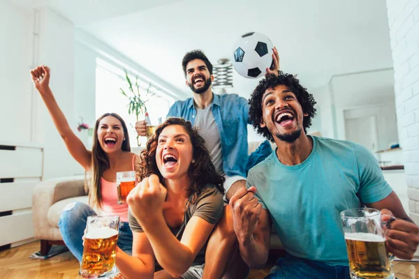 Happy friends or football fans watching soccer on tv and celebra — Stock Photo, Image