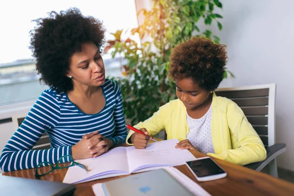 Mother and daughter doing homework learning to calculate — Stock Photo, Image