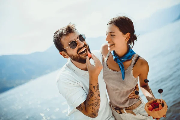 Jong stel het eten van fruit op het strand-zomerfeest met vriend — Stockfoto