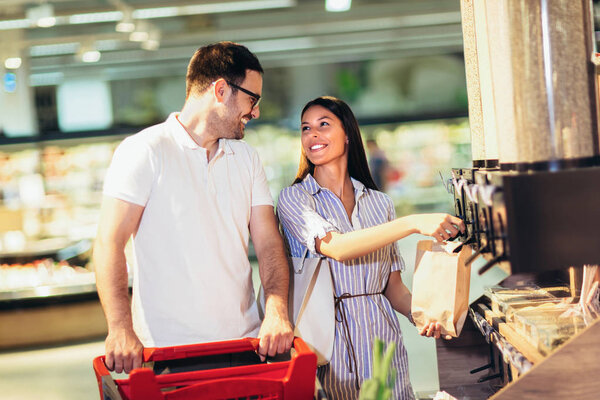 Woman is bying products in zero waste shop