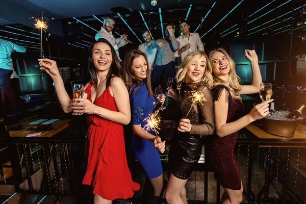 Group of friends partying in a nightclub