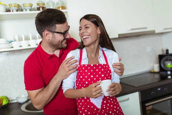 Beautiful young couple is hugging and smiling while drinking cof — Stock Photo, Image