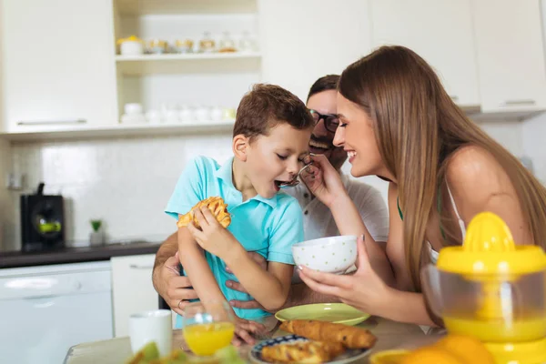Familia Comer desayuno en la mesa de la cocina —  Fotos de Stock