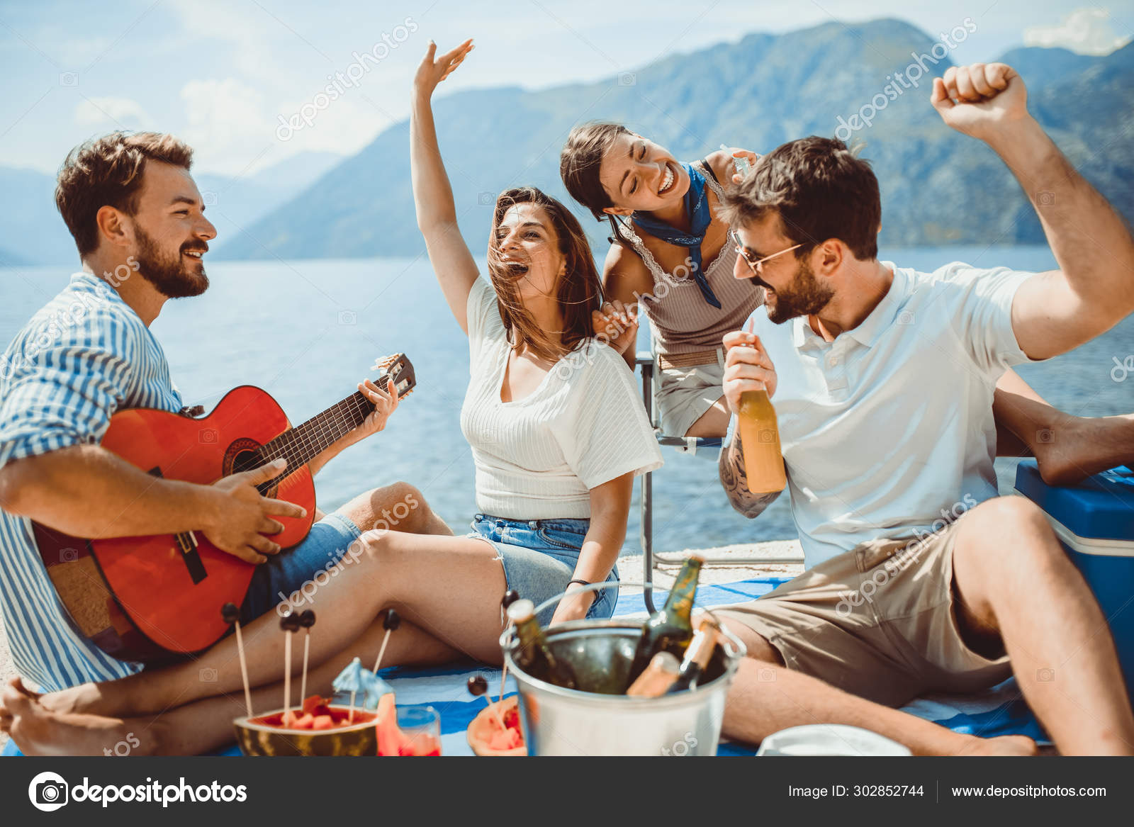 Young people having fun on summer vacation.Happy friends drinkin Stock  Photo by ©adriaticphoto 302852744