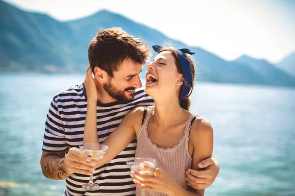 Bella coppia divertirsi in spiaggia, bere cocktail e — Foto Stock