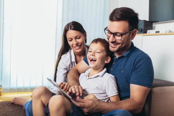 Happy family spending time at home and looking something fanny o — Stock Photo, Image