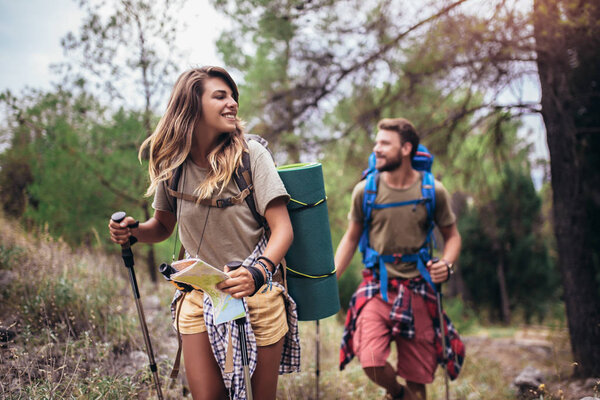 Backpackers hiking on the path in mountains 