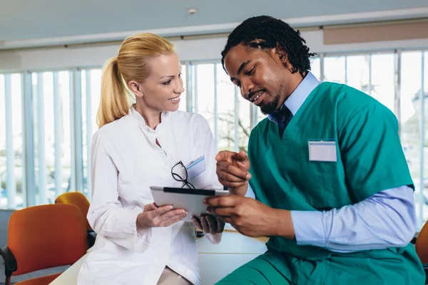 Equipe médica sentada e discutindo na mesa no escritório . — Fotografia de Stock