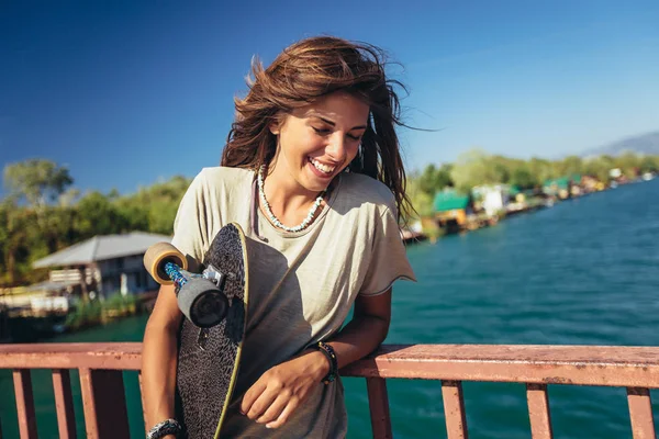 Belle et mode jeune femme posant avec un skateboard — Photo