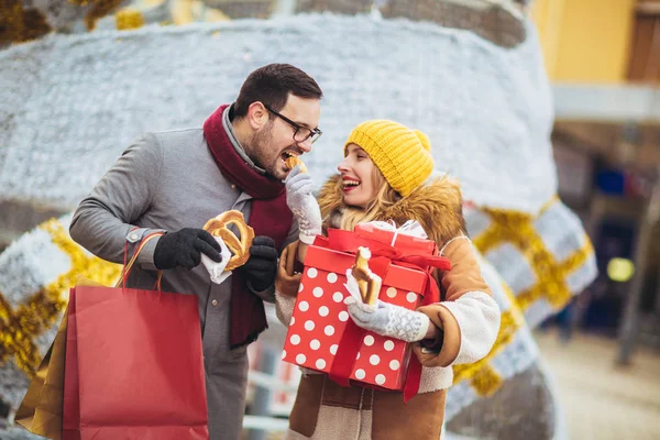 Jong stel gekleed in winter kleding houden geschenkdozen elkaar overtreffen — Stockfoto