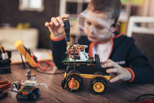 Mutlu gülen çocuk teknik oyuncaklar yapıyor. Sekmedeki teknik oyuncak