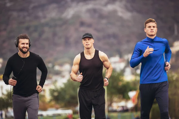 Jonge sporters het beoefenen van een run op atletiek stadion bijhouden. — Stockfoto