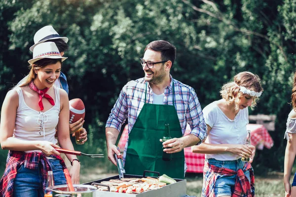 Friends having a barbecue party in nature