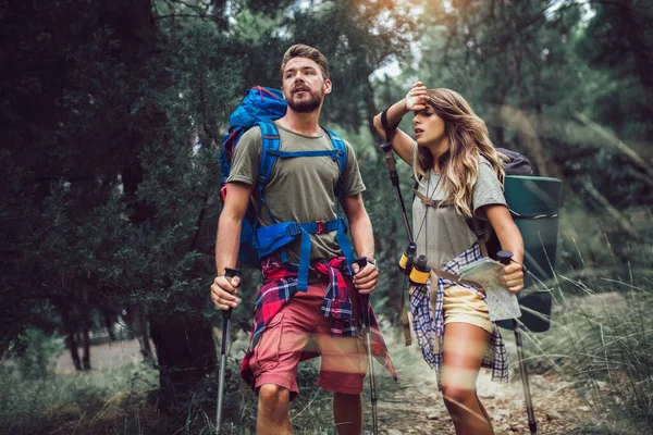 Happy young couple hiking together.