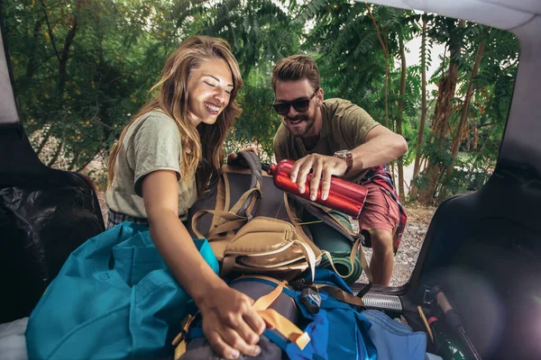 Ungt Par Har Det Sjovt Mens Udpakning Camping Udstyr - Stock-foto