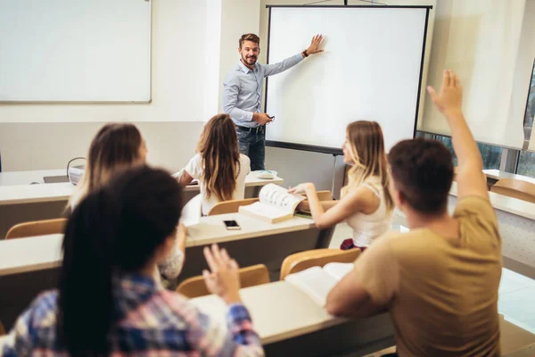 Usmívající Učitel Stojící Před Studenty Ukazující Něco Bílém Prkně Třídě — Stock fotografie