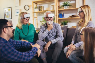 Portrait of a three generation family spending time together at home playing game guess who.