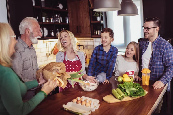 Multi Generation Family Cooking Meal At Home