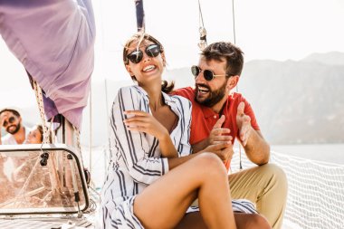 Sevgi dolu çift denizde yatta mutlu vakit geçiriyor. Deniz kenarında lüks bir tatil.. 